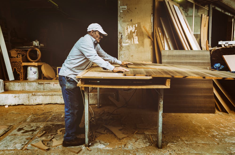 man cutting a wood